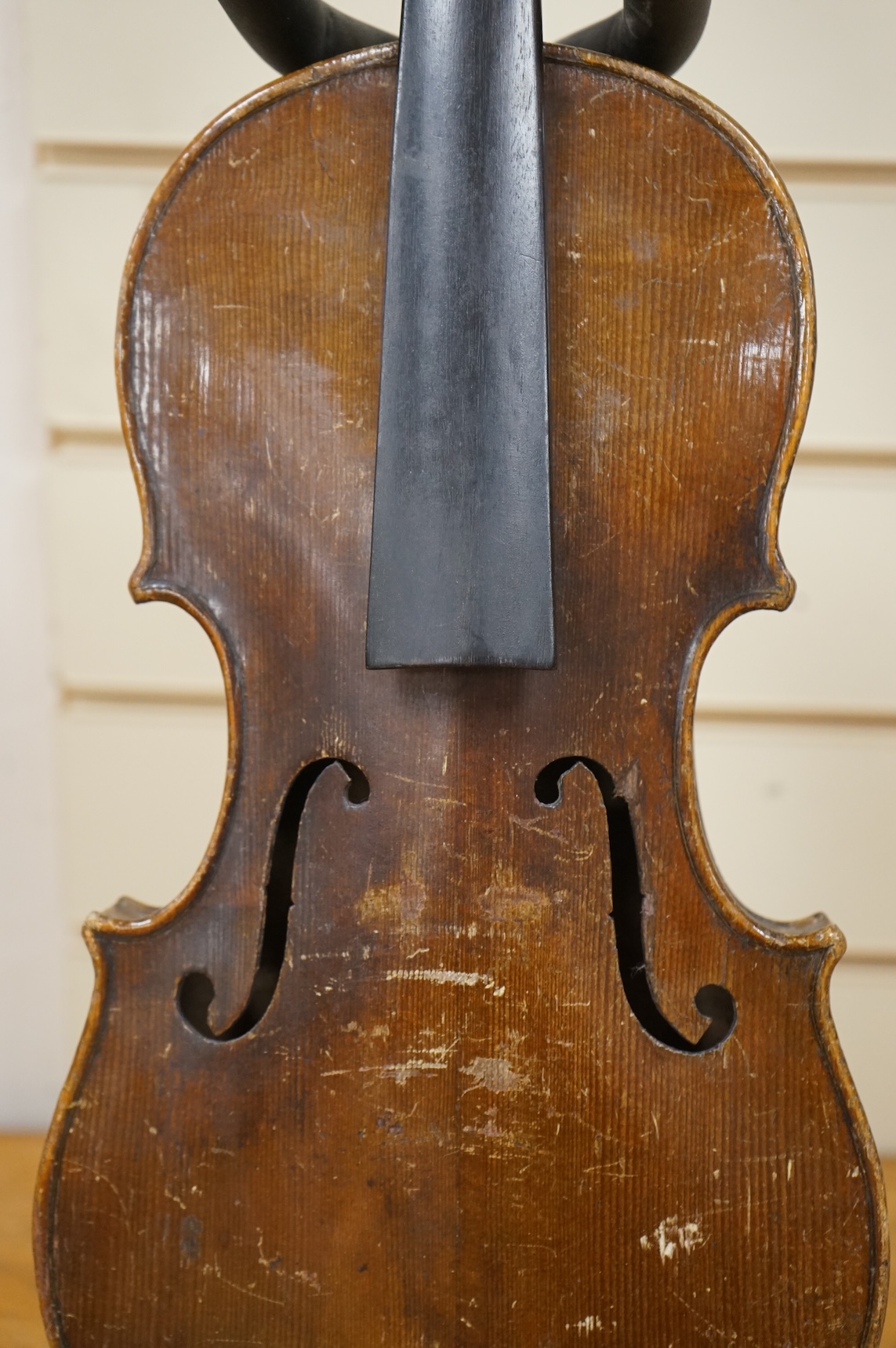 Four violins; a German Dresden violin, together with further two German violins, and a Saxony violin, three in cases or the remains of cases.